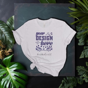 May include: White t-shirt with a purple design that says "your design here" and "MockAndLockIt" below it.