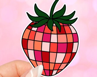 Puede incluir: Una pegatina de fresa roja, rosa y naranja con un tallo y hojas verdes. La fresa está hecha de pequeños cuadrados.