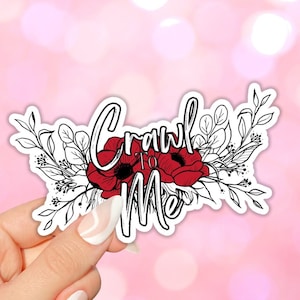May include: A black and white floral design with red flowers and the text "Crawl to Me" in white.
