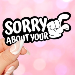 May include: Black and white sticker with the text "Sorry about your" and a cartoon hand giving a thumbs down gesture.