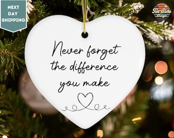 May include: White ceramic heart-shaped ornament with black text that reads "Never forget the difference you make" and a small heart with a swirl design.