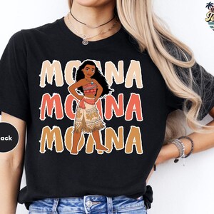 A black t-shirt with a graphic design featuring the character Moana from the Disney animated film "Moana".