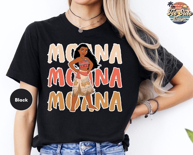 A black t-shirt with a graphic design featuring the character Moana from the Disney animated film "Moana".