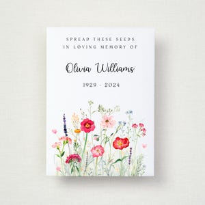 May include: A white card featuring the text "SPREAD THESE SEEDS IN LOVING MEMORY OF Olivia Williams 1929-2024" above a watercolour illustration of vibrant wildflowers, including red, pink, and blue blooms.