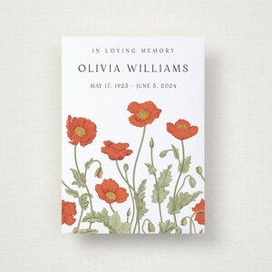 May include: A white card with the text "IN LOVING MEMORY" and the name "OLIVIA WILLIAMS" with dates. The card features a floral design of red poppies with green leaves and stems.