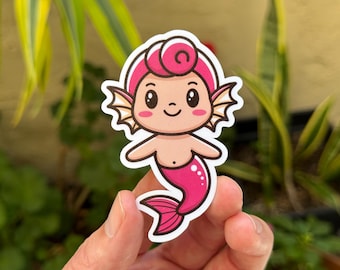 May include: A pink cartoon mermaid with a pink tail and a swirl on top of its head. The mermaid has a light pink body and a light pink face with big eyes and a smile.