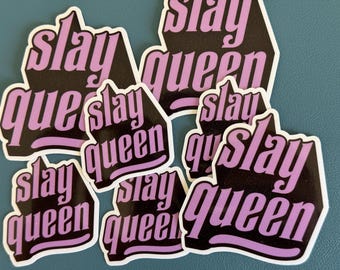 May include: A set of six stickers with the phrase "slay queen" in black and purple lettering. The stickers are arranged in a pile, with the top sticker showing the phrase "slay queen" in all caps.