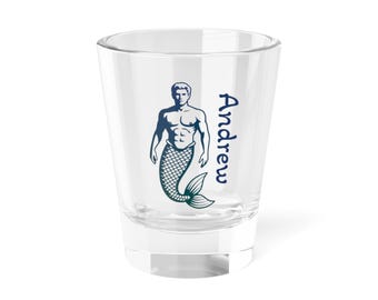 May include: A clear glass shot glass with a blue and green mermaid illustration and the name "Andrew" printed on the side.