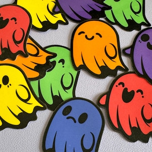 May include: A set of ten colourful ghost stickers with black outlines. Each ghost has a different expression and is a different colour, including red, orange, yellow, green, blue, and purple.
