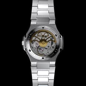 May include: A silver stainless steel wristwatch with a transparent back, showcasing the intricate gold-colored automatic movement. The watch features a silver band and is water-resistant to 5 ATM. The back of the watch is labeled "Sapphire" and "Crystal 5 ATM".