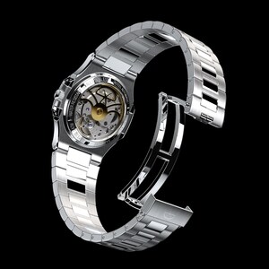 May include: A stainless steel wristwatch with a silver band and a transparent back, revealing the intricate inner workings of the automatic movement. The watch is water-resistant and features a crystal face. The band is open, showcasing the clasp.