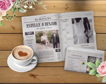May include: A wedding newspaper with the headline "ESTELLE & BENJAMIN Are Getting Married." A coffee cup with a heart design sits on a saucer. Pink roses and greenery decorate the wooden surface.