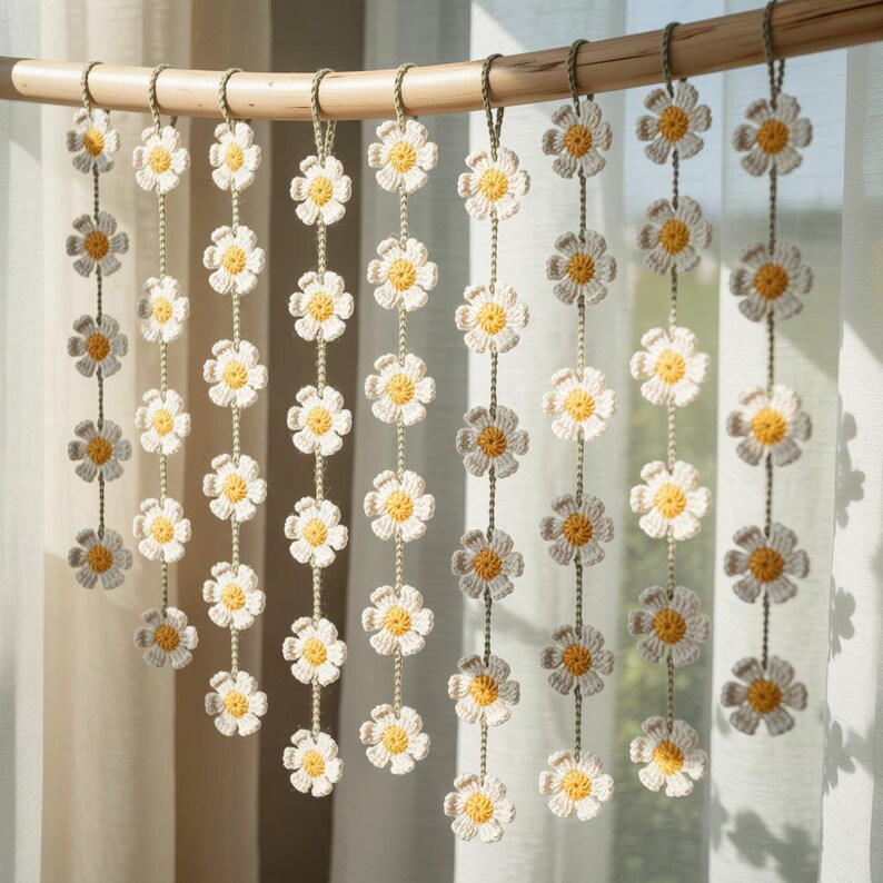 May include: A decorative curtain made of crocheted daisy flowers. The daisies are white with yellow centers and are strung together with green thread. The curtain hangs from a natural bamboo rod, creating a charming, handmade aesthetic.