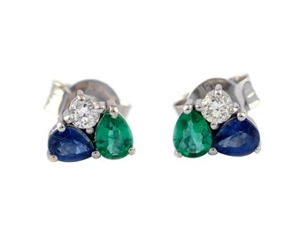 May include: A pair of silver earrings with a cluster of three gemstones. The earrings feature a round, clear diamond in the center, surrounded by two pear-shaped gemstones, one green and one blue.