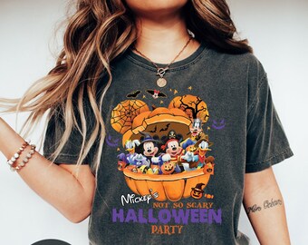 May include: A dark grey t-shirt with a graphic of Mickey Mouse and friends in a pumpkin. The text on the shirt reads "Mickey's Not So Scary Halloween Party".