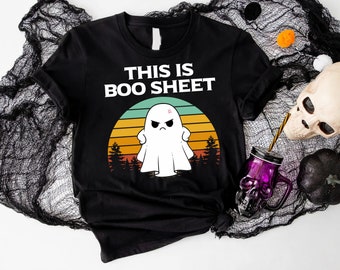 May include: Black t-shirt with a white ghost and the text "This is Boo Sheet" in a retro sunset design.