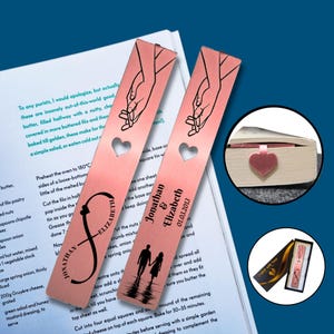 May include: Two pink metal bookmarks with a heart cutout and a design of two hands holding each other. One bookmark has the names Jonathan & Elizabeth and the date 01.03.2013. The other bookmark has the names Jonathan & Elizabeth with a stylized infinity symbol.