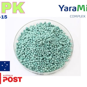 May include: A close-up of a bowl of blue-green fertiliser granules. The label reads "NPK 12-5-15 YaraMila COMPLEX".