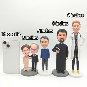 May include: A collection of custom bobblehead figurines, ranging from 6 to 9 inches tall, depicting various professions and occasions. Includes a bride and groom, a man in a suit, a man in a blue sweater, a priest, and a doctor. An iPhone 14 is included for scale.