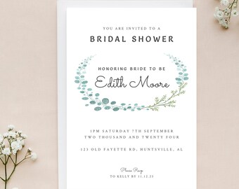 May include: A white card with a green and blue floral wreath design. The text reads "You are invited to a Bridal Shower Honoring Bride to be Edith Moore 1 PM Saturday 7th September Two Thousand and Twenty Four 123 Old Fayette Rd, Huntsville, AL Please RSVP to Kelly by 11.12.23"
