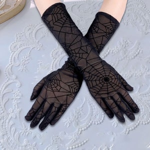 May include: A pair of black, sheer gloves with a spiderweb design. The gloves are long, extending past the wrist, and feature a detailed web pattern across the entire surface. The gloves are made of a lightweight material.