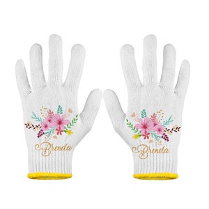 May include: A pair of white cotton gardening gloves with a floral design and the name "Brenda" embroidered on each glove.