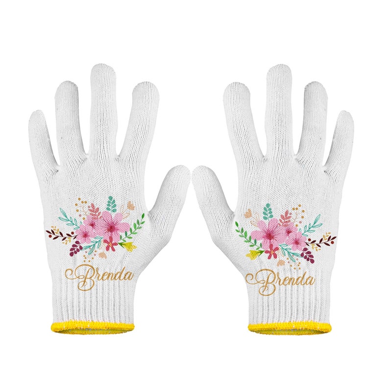 May include: A pair of white cotton gardening gloves with a floral design and the name "Brenda" embroidered on each glove.