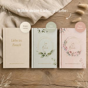 May include: Three hardcover pregnancy journals titled Liebe im Bauch. The left is beige linen, the center is mint green with eucalyptus leaves, and the right is pink with floral wreaths. Each book features gold text and a subtitle.