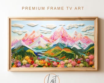 May include: A framed artwork depicting a colorful, embroidered landscape with mountains, a lake, and a field of flowers. The mountains are pink, white, and green, and the lake is blue. The field of flowers is a mix of pink, yellow, and purple.