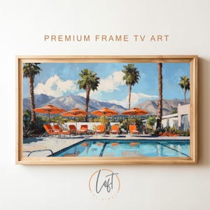May include: A painting of a swimming pool with palm trees and lounge chairs. The pool is surrounded by a white fence and there are mountains in the background. The painting is in a wooden frame.