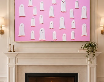 May include: A rectangular wall art piece featuring a repeating pattern of white ghost figures with simple facial features against a solid pink background. The ghosts are arranged in a scattered layout across the entire surface of the print.