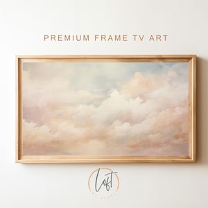 May include: A framed print of a painting depicting a sky filled with soft, pastel pink and white clouds. The clouds are painted in a realistic style, with subtle variations in color and texture. The frame is a simple, light wood color.