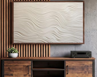 May include: A rectangular wall art piece featuring a white, textured surface with flowing, wave-like relief patterns, framed in dark wood. The artwork is mounted on a wall with vertical wooden slats and a gray concrete-textured section.