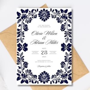 May include: A white wedding invitation with a navy blue floral border. The text reads "You are invited to the wedding of Olivia Wilson & Adrian Miller, Sunday, Sept 28, 2023 at 3 PM, Olivia Wilson Hall, 123 Anywhere St, Any City, Reception to follow."
