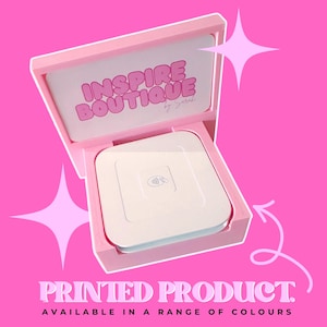 May include: A light pink wooden display stand holding a white square contactless payment card reader. The back panel features the text INSPIRE BOUTIQUE by Sarah in pink lettering. The image includes pink star graphics and white text.