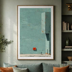 May include: A framed abstract art print with a teal background and a red square. The artwork hangs above a teal sofa with orange and green pillows. A coffee table with a book and a vase is in front of the sofa.