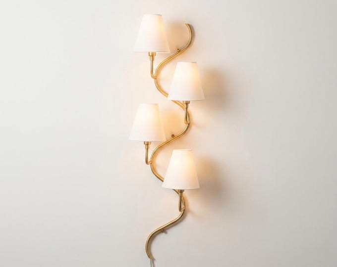 The Gold Brass wall sconce — where sophistication meets light.