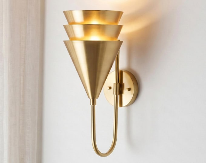 Triple-tiered shades in gold and glass for multi-directional, flattering light.