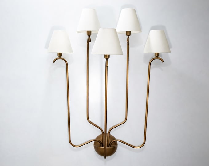 Modern grace wrapped in the heritage of the Brown Antique wall sconce.