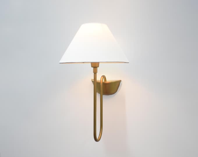 Modern grace wrapped in the heritage of the Brown Antique wall sconce.
