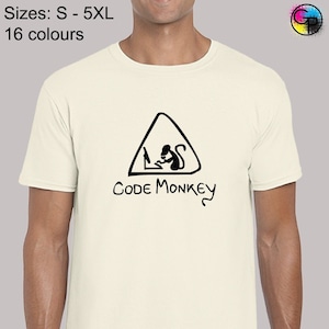 May include: White t-shirt featuring a black graphic of a monkey sitting at a computer inside a triangle with the text "CODE MONKEY" underneath.