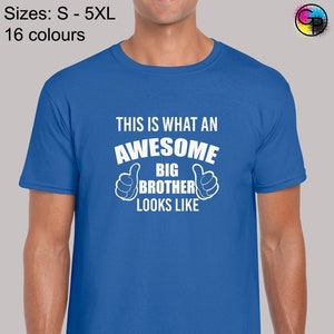 May include: A royal blue t-shirt with white text that reads "This is what an awesome big brother looks like" with two thumbs up symbols on either side of the text.