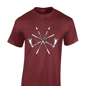 May include: A maroon t-shirt featuring a white graphic of crossed spears and tomahawks.