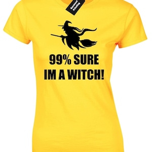 May include: Yellow t-shirt featuring a black silhouette of a witch flying on a broomstick. The text "99% SURE IM A WITCH!" is printed below the image.