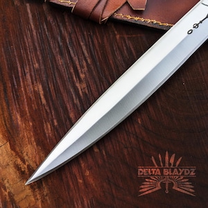 Handmade Paul Atreides Crysknife Replica: Dune Movie Carbon Steel Short Sword with Leather Sheath
Dune Knives: Movie Replica Handmade Knives | Gift for Men | Birthday Gift | Free Sheath | Movie Props | Christmas Gift | Dune 2024 Knife | Personalized Knife | Gift for Him | Anniversary Gift | Wedding Gift | Outdoor Knife | Hunting Knife | Groomsmen Gift Knife | Best Men Gift