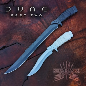 May include: Two swords, one with a black handle and a serrated blade, the other with a white handle and a curved blade. The swords are on a wooden surface. The text "DUNE PART TWO" is at the top of the image.
