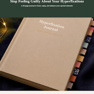 May include: A tan journal with the text Hyperfixation Journal printed on the cover. The journal features a series of colourful, patterned index tabs along the side. The top header text reads Stop Feeling Guilty About Your Hyperfixations.