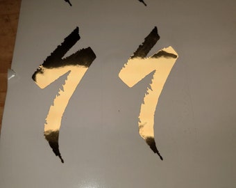 Logo autocollant Specialized S Logo en or d'environ 8 cm de haut.