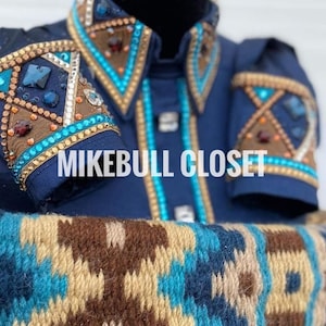 May include: A navy blue show shirt with intricate embellishments. The shirt features turquoise, brown, and gold accents, with sparkling gemstones and detailed patterns on the collar and sleeves. The text "MIKEBULL CLOSET" is visible.