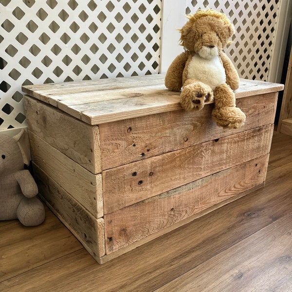 Rustic wooden storage box with hinged lid.